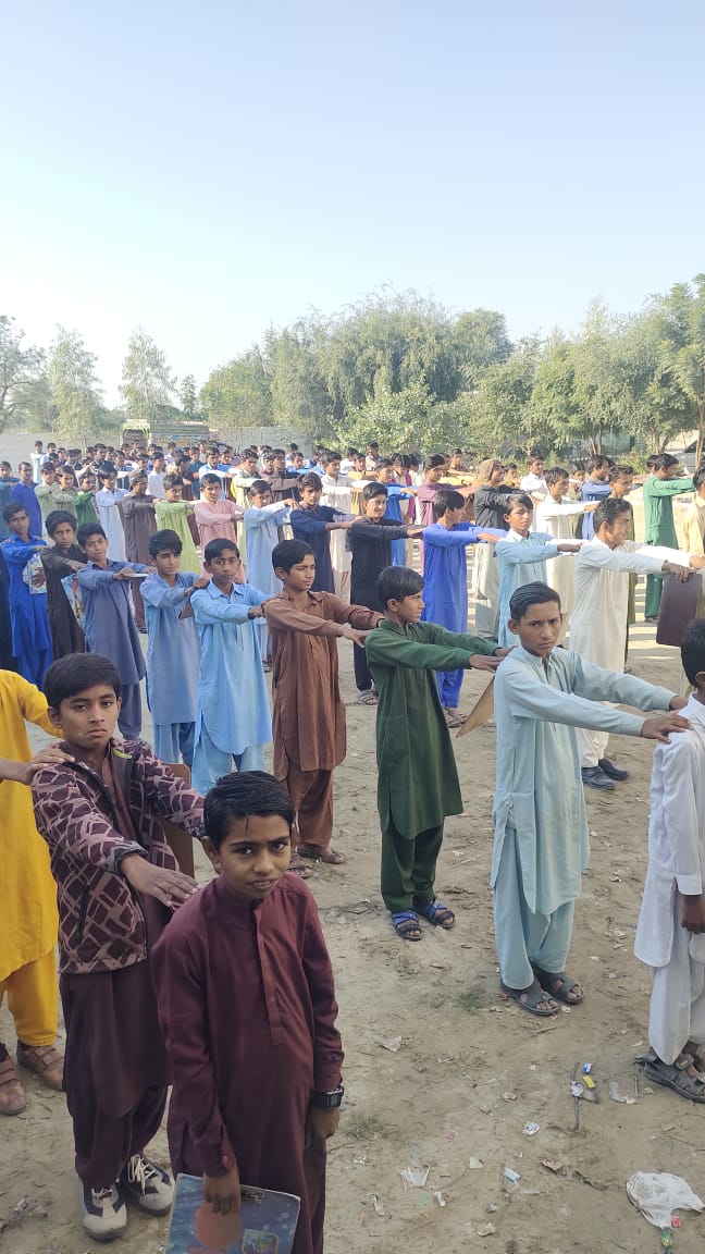 Rows of students at outdoor assembly