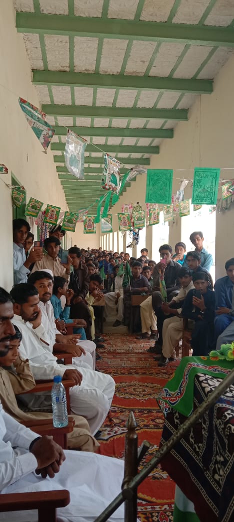 Students gathered under a decorated veranda for a school event
